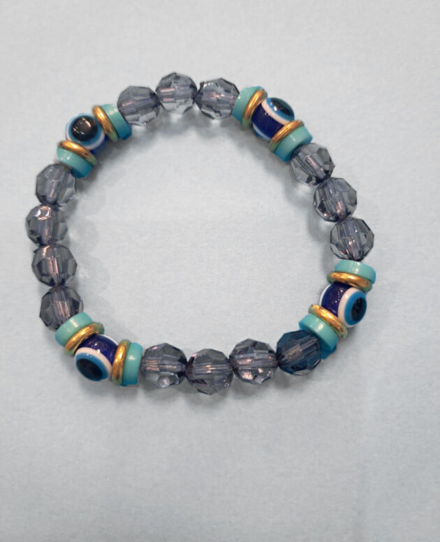 Evil eye bracelet with gold and turquoise spacers and grey translucent beads